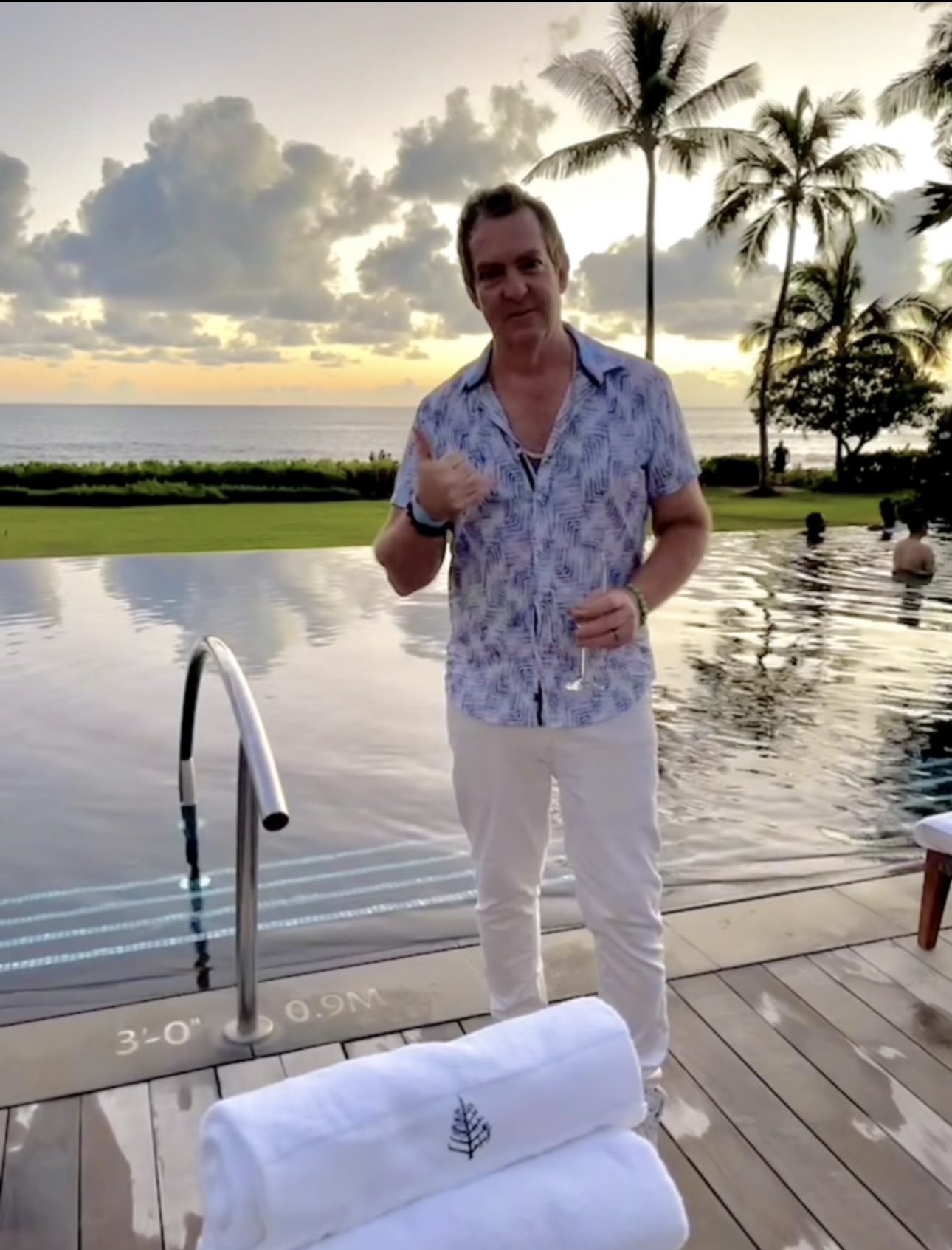 Jason Roe standing near water and palm trees